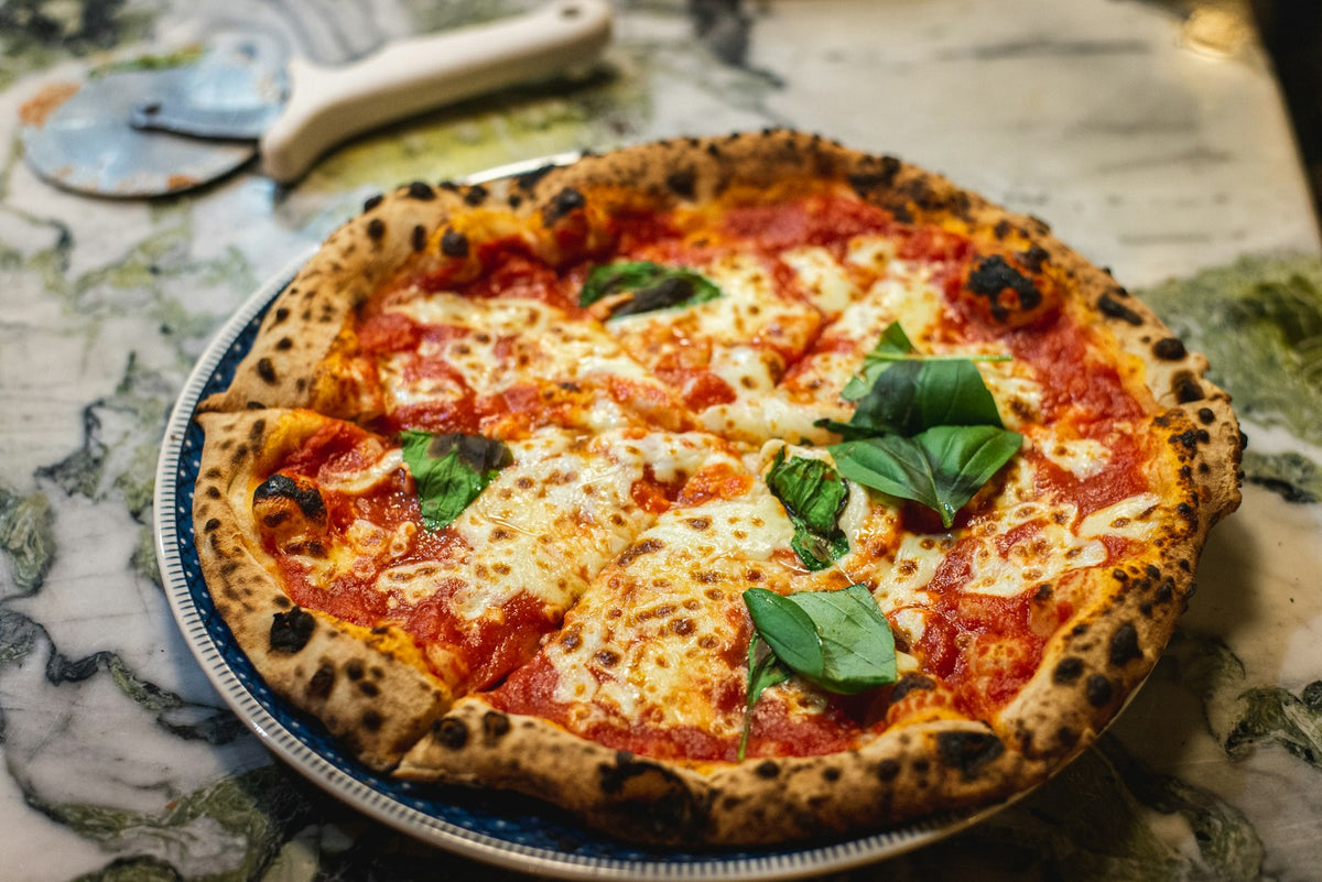 Pizza topped with cherry tomatoes and basil